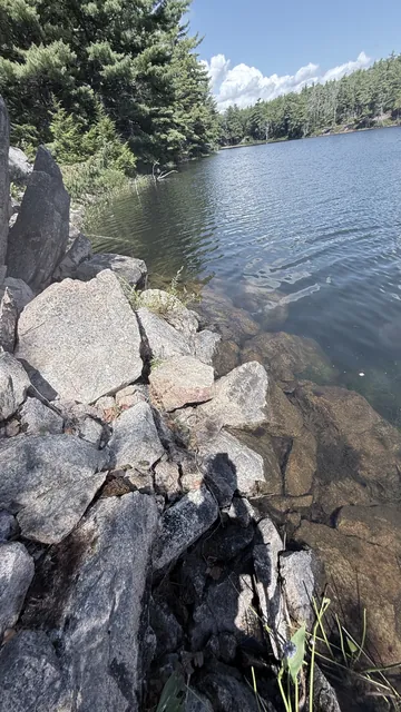 Granite blocks running down into the water, the old steps now covered by the lake