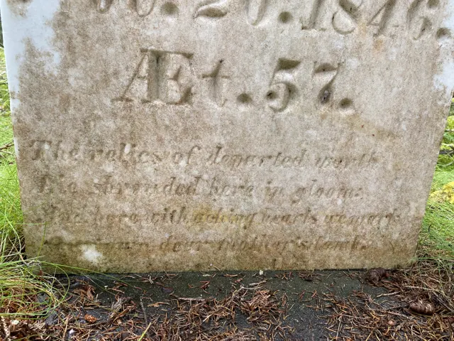 Close view of the lower part of the headstone with the age and the four-line verse