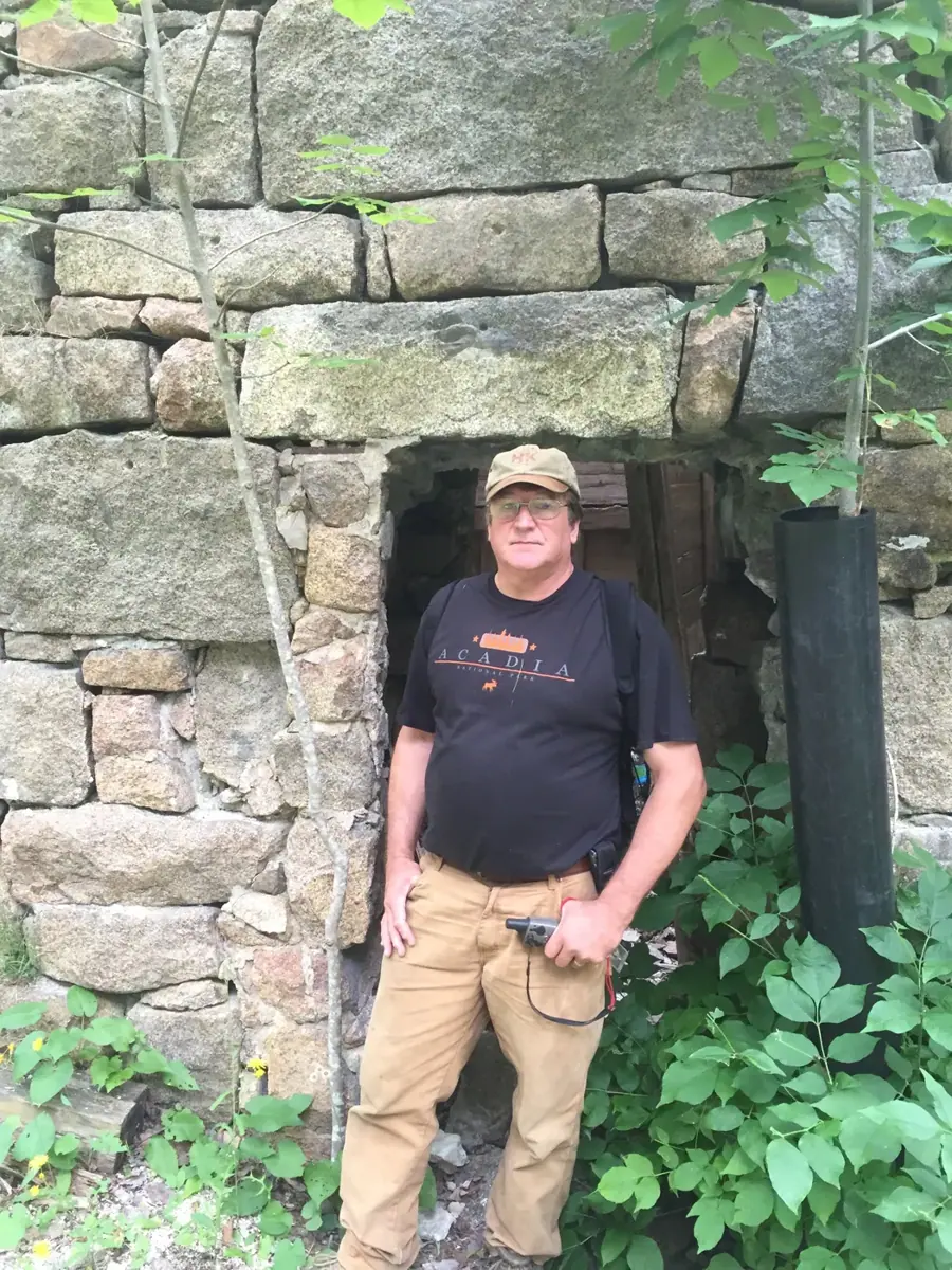 Peter Heilakka standing in the doorway of the stone tower
