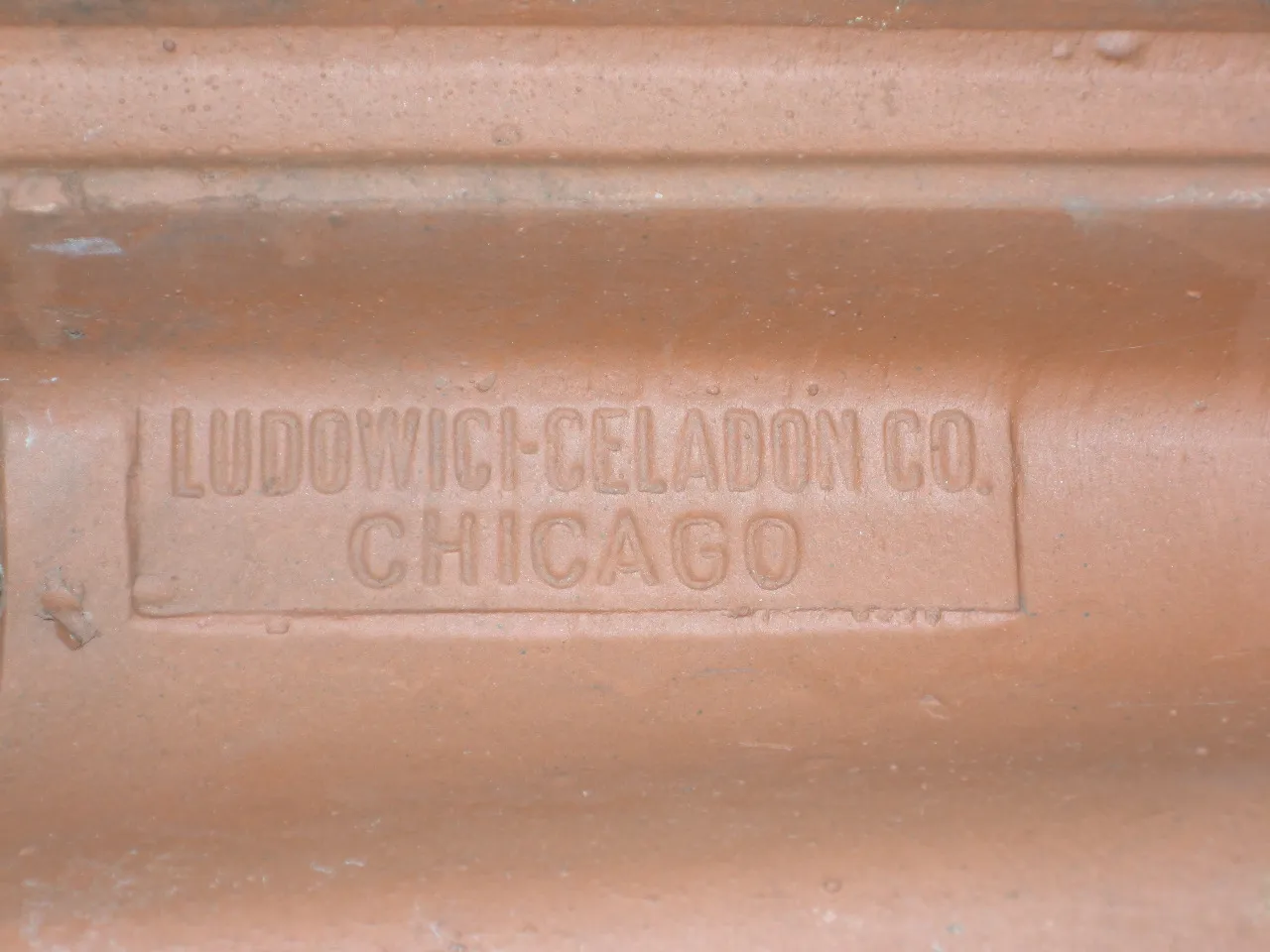 Close view of a red clay roof tile stamped Ludowici-Celadon Co. Chicago