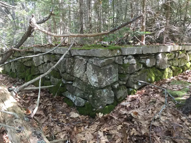 A corner of the dry-laid stone platform of the Pine Hill picnic pavilion, capped with flat stones