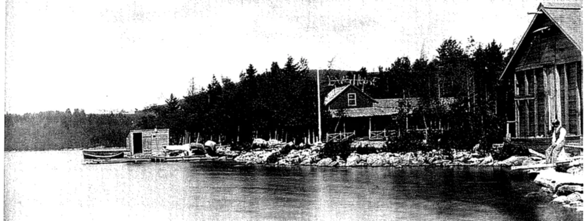 Small hotel and boathouse on the shore of a lake